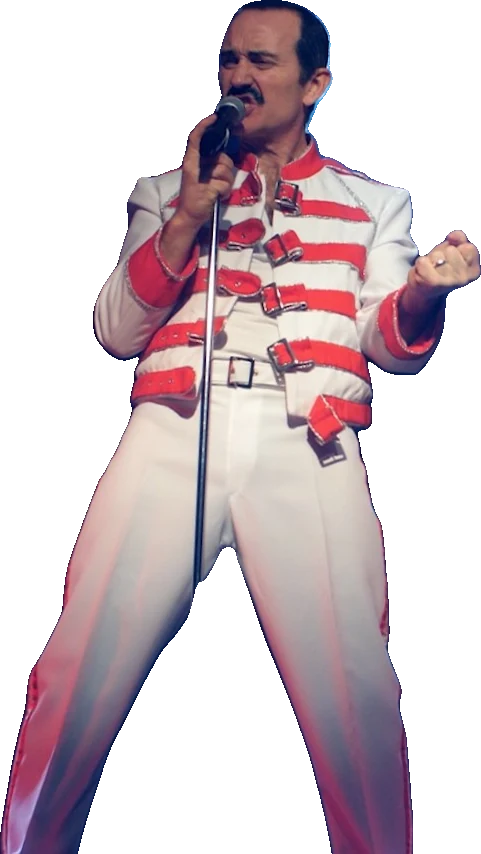 Eddie Devlin as Freddie Mercury in the white and red buckled jacket, singing with a clenched fist